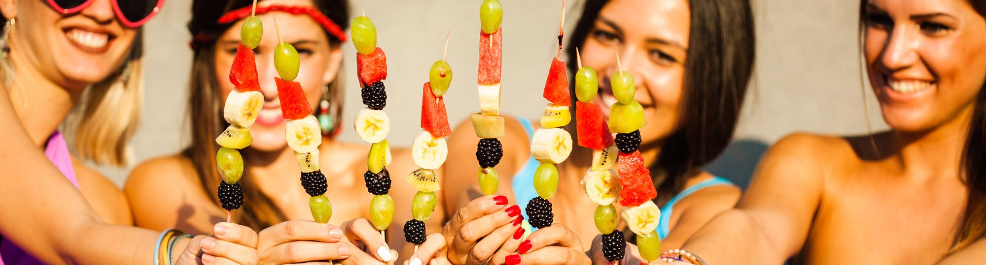 fruitbouquets.com deal hero girls eating fruit kabobs